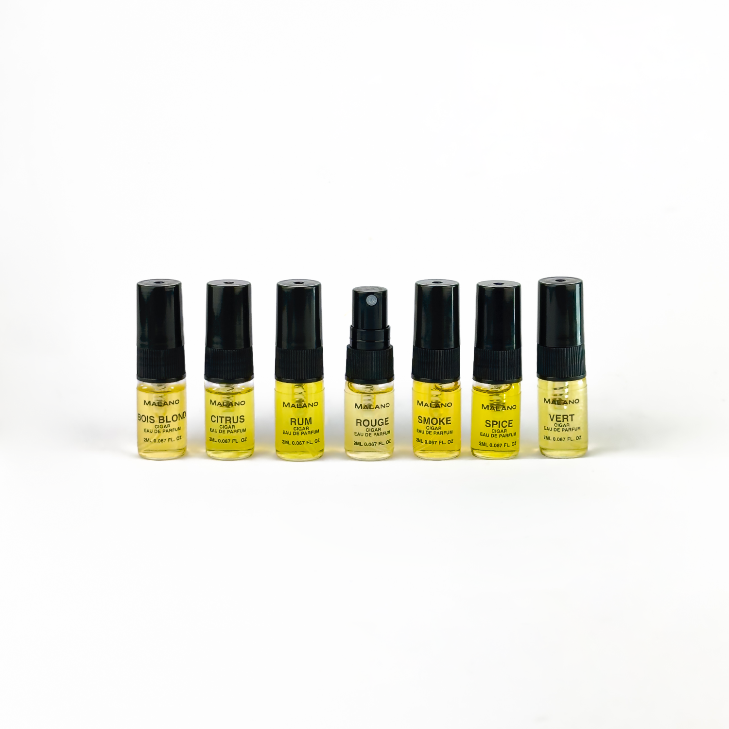 the Cigar collection of seven small, clear glass bottles with black atomiser nozzles, each filled with perfume, arranged in a line on a white background.