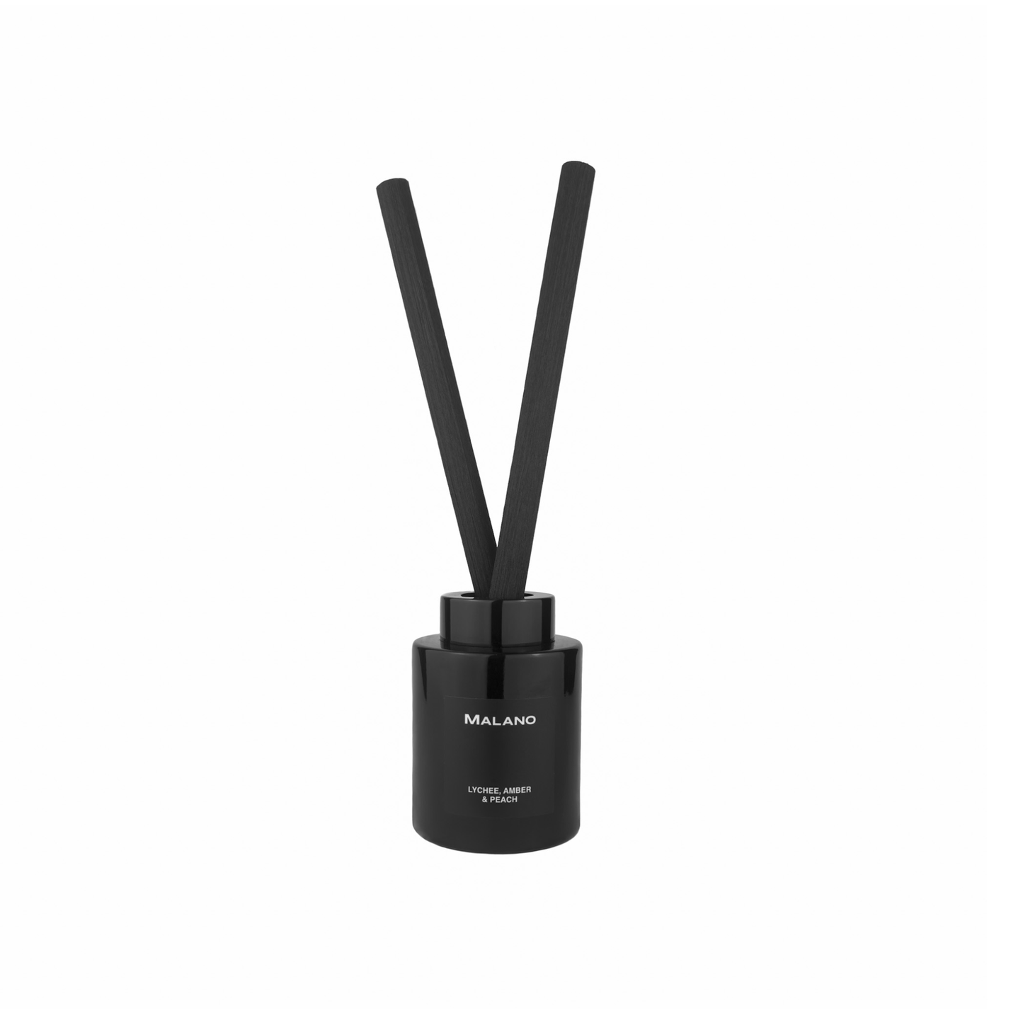 A black reed diffuser with 2 thick, long, reeds inserted into a cylindrical glass container with a label of the scent ‘Lychee, Amber and Peach’ brand ‘Malano’ on it.