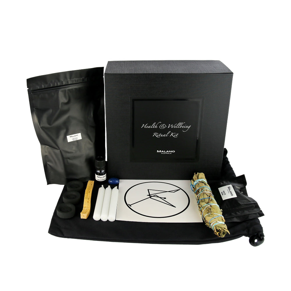A Health and Wellbeing Positive Intention Ritual Kit by Malano with it’s box and contents layed out in a tidy and organised manner including a bag of Himalayan Pink Salt, Anointing Oil, Charcoal, a stick of Palo Santo, three white candles, a gem stone, blessing sigil, Costal Swamp Paperbark, Coastal Tea Tree and Pandanus smudge stick and Health and Wellbeing Resin. These elements are sitting ontop of a black drawstring bag and against a white background.