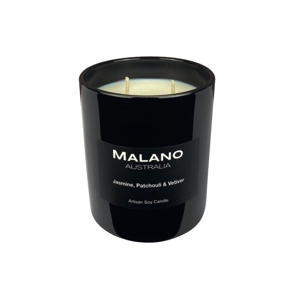 A creamy white handpoured Australian artisan soy wax candle with two wicks, branded 'Malano', with a scent of Jasmine, Patchouli & Vetiver in a large glossy black glass jar sitting against a white background.