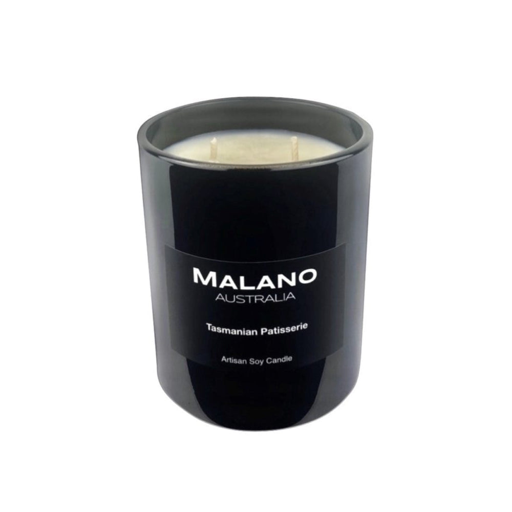 Black gloss glass jar containing a luxury Australian artisan, hand poured, scented soy wax candle by Malano with a Gourmand scent of Tasmanian Patisserie against a white background