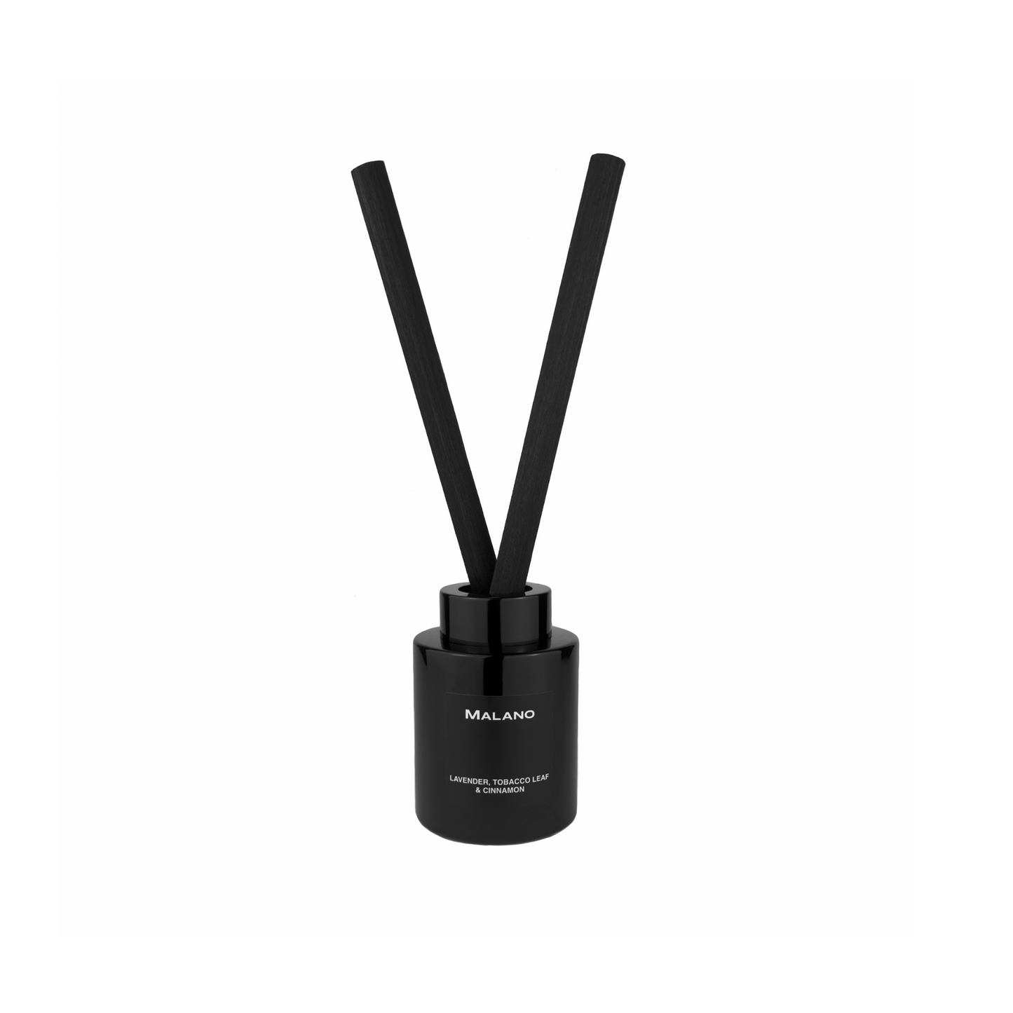 A black reed diffuser with 2 thick, long,  reeds inserted into a cylindrical glass container with a label of the brand ‘Malano’ and the scent of ‘Lavender, Tobacco Leaf and Cinnamon’ on it.