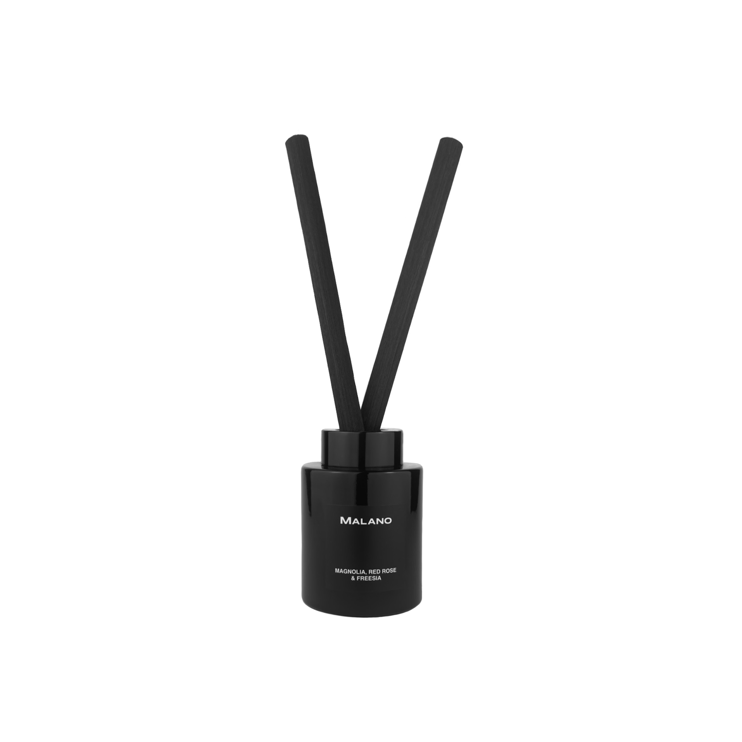 A black reed diffuser with 2 thick, long,  reeds inserted into a cylindrical glass container with a label of the brand ‘Malano’ and the scent ‘Magnolia Red Rose and Freesia’ on it 