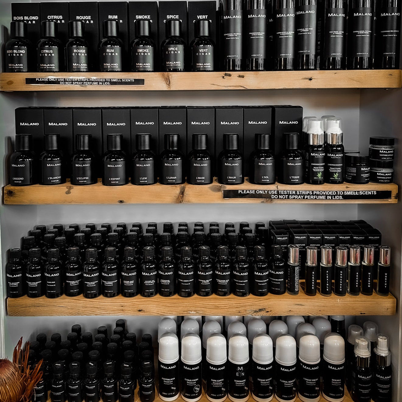 Shelves at with various Malano products, black and white bottles or perfume, body care and fragrance products in the Stella Arden Boutique in Hobart, Tasmania