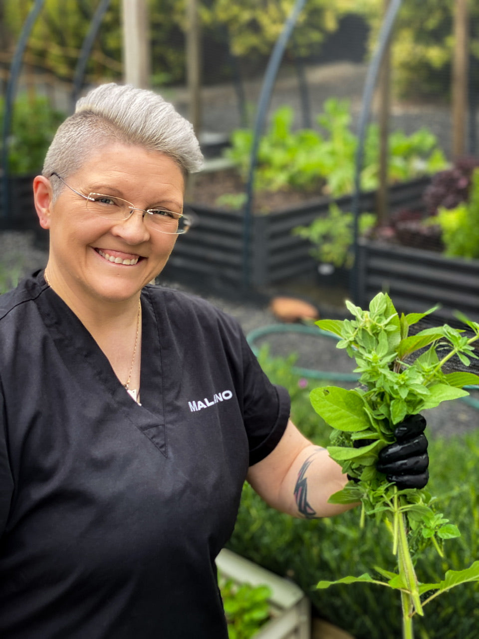 Maryka chief product maker in the garden on their property picking some mint for infusion into their new Tasmanian Perfume