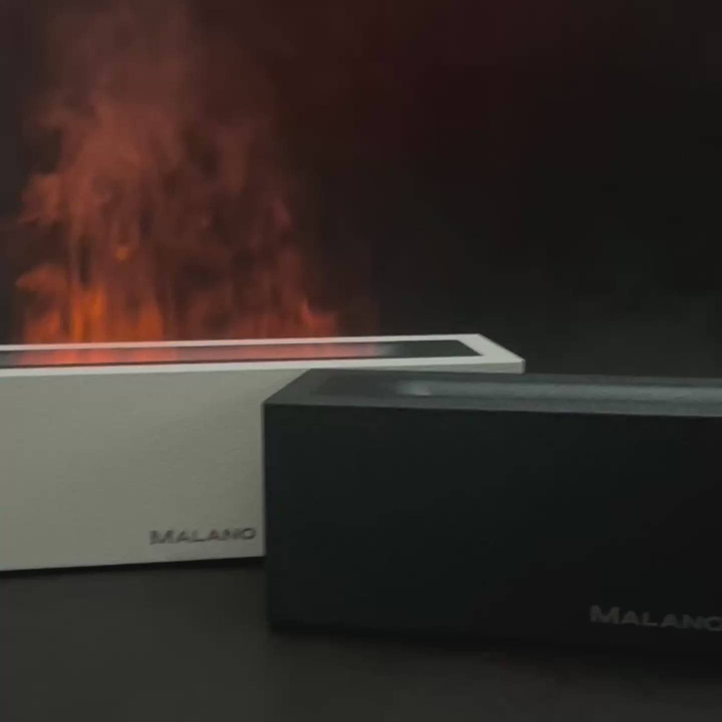 video showing a black and white diffuser and humidifier,  turned on showing their effects both with a flame like effect and without the light on. The diffusers have the brand name Malano sitting on the bottom front, centre of the diffuser. 