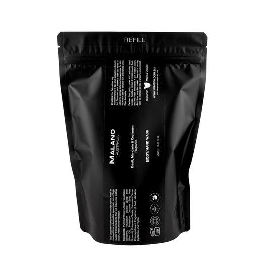 A black refill bag that has a label with the brand Malano and Basil, Mandarin and Cyclamen Body/Hand Wash written in white and the bag sitting against a white background with a capacity of 500mL