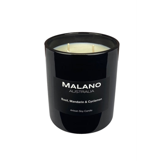 Black gloss glass jar containing an Australian artisan scented hand poured  soy wax candle by Malano with green, citrus scent of Basil, Mandarin and Cyclamen, sitting against a white background