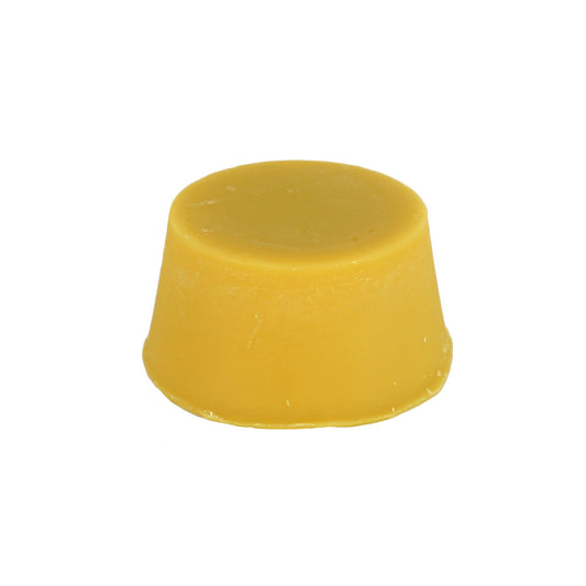 A solid dark creamy yellow  coloured dark hair organic conditioner bar made by Malano against a white background.