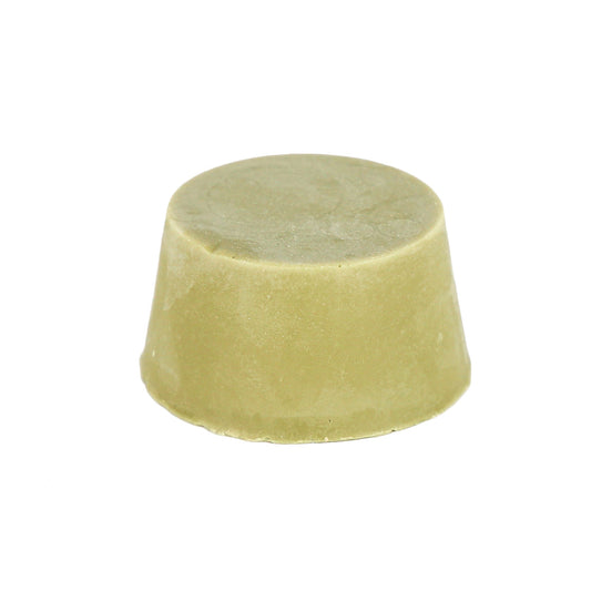 A light creamy green coloured shampoo bar  with a smooth, rounded shape on a white background. This shampoo bar is for use with dark hair.