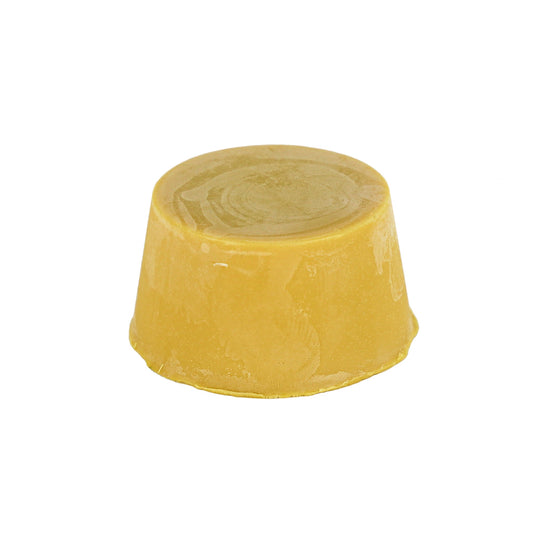 Deep Cleanse shampoo bar, a yellow, round shampoo block against a white background.