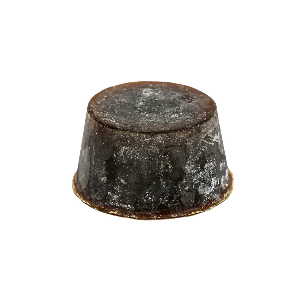 A round bar of soap with a dark brown to black colour gradient, containing  a specialty scent of Guinness, Lemon Myrtle, or Sandalwood.