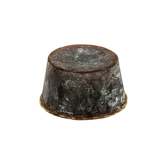 A round bar of soap with a dark brown to black colour gradient, containing  a specialty scent of Guinness, Lemon Myrtle, or Sandalwood.