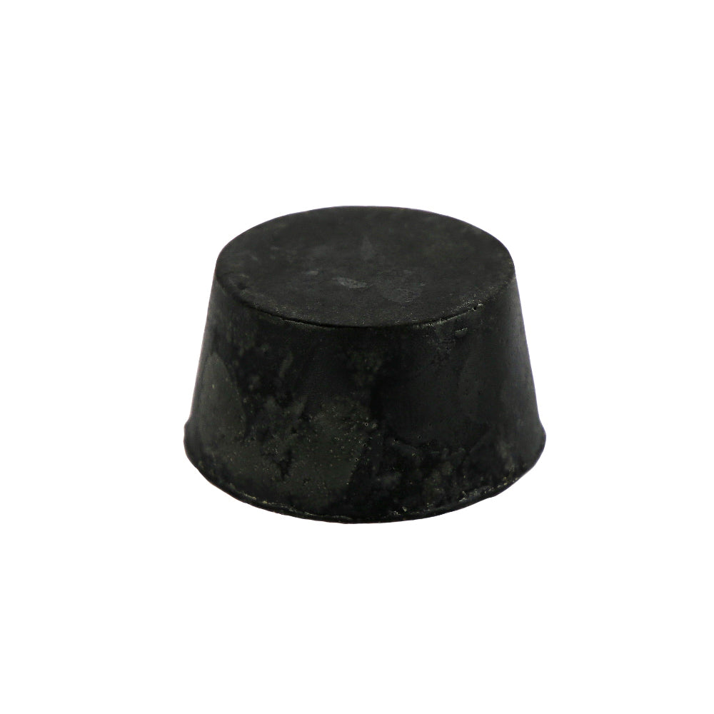 A round, black colored soap block with a smooth surface and infused with guinness, activated charcoal and patchouli.