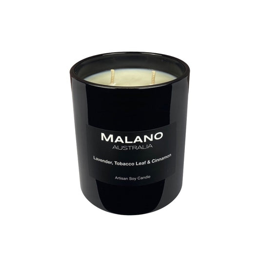 Black gloss glass jar containing a hand poured scented soy candle by Malano Australia, featuring a dry woody, floral scent of Lavender, Tobacco Leaf and Cinnamon. Sitting against a white background