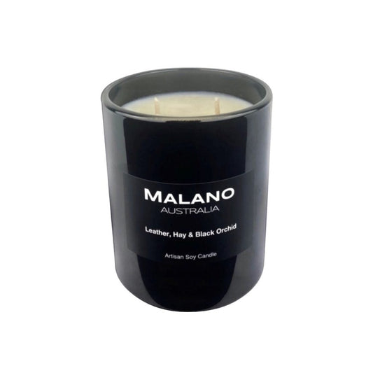 Black gloss glass jar containing a luxury Australian artisan, hand poured, scented soy wax candle by Malano with a woody, oriental, floral  scent of Leather, Hay and Black Orchid,  sitting against a white background.