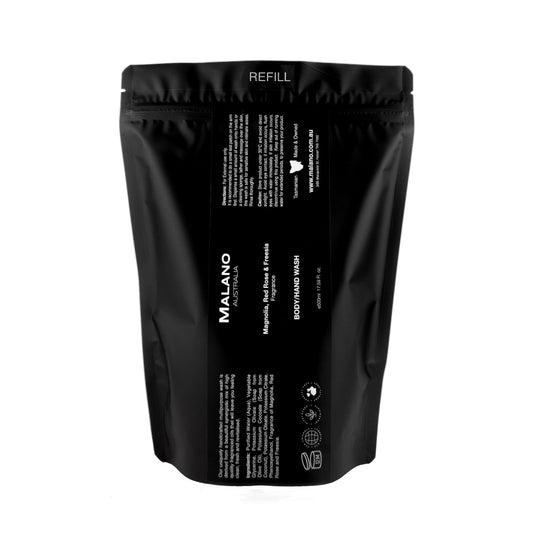 A black refill bag  labeled 'Malano nBody/Hand Wash with the scent of Basil, Mandarin, and Cyclamen sitting against a white background with a capacituy of 500mL