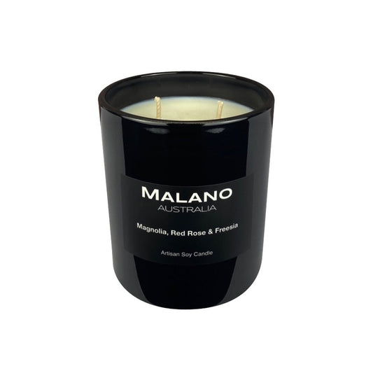 A black Australian artisan hand-poured soy wax candle in a black glass jar with two wicks, labeled 'MALANO' and scented with Magnolia, Red Rose & Freesia.