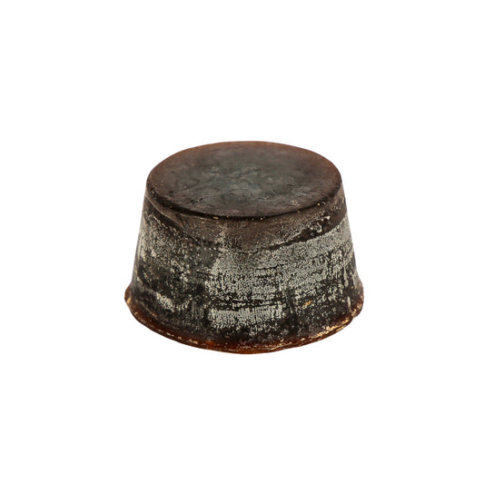 A solid block of dark brown coloured Orchid, Musk and Sandalwood scented soap with a textured surface.
