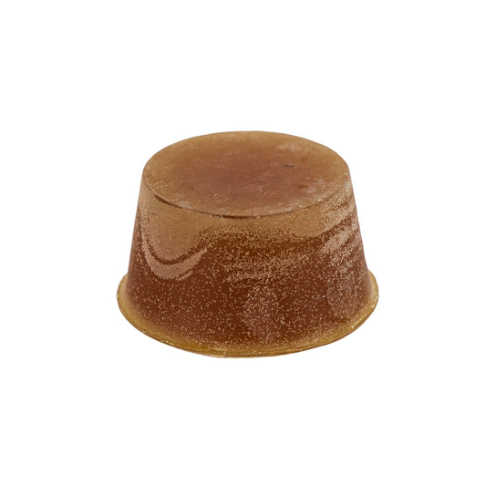 Organic round block of Sandalwood Soap, dark orange in colour and sitting against a white background