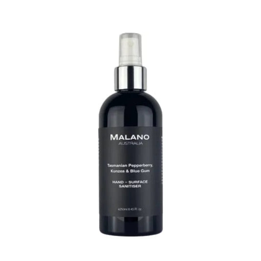 A little black bottle with a silver and white spray nozzle, a clear lid, and with a black label and white writing that reads ‘Malano, Tasmanian Pepperberry, Kunzea and Blue Gum, Hand-Surface Sanitiser’ with a capacity of 250mL, the bottle is sitting against a white background 