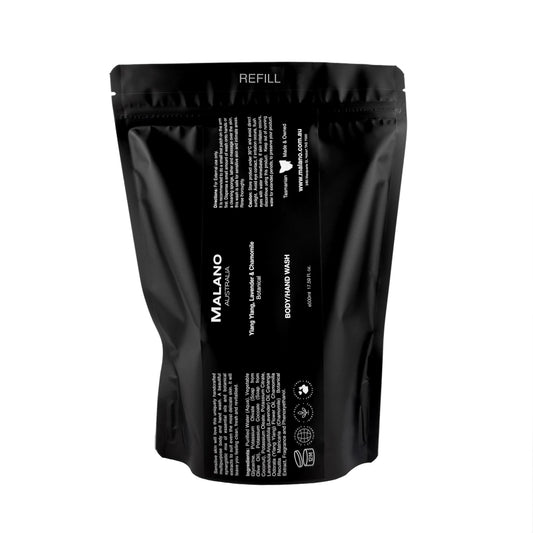 A black refill bag labeled 'Malano Body/Hand Wash with the scent of Ylang Ylang, Lavender and Chamomile, in 500mL, sitting against a white background.