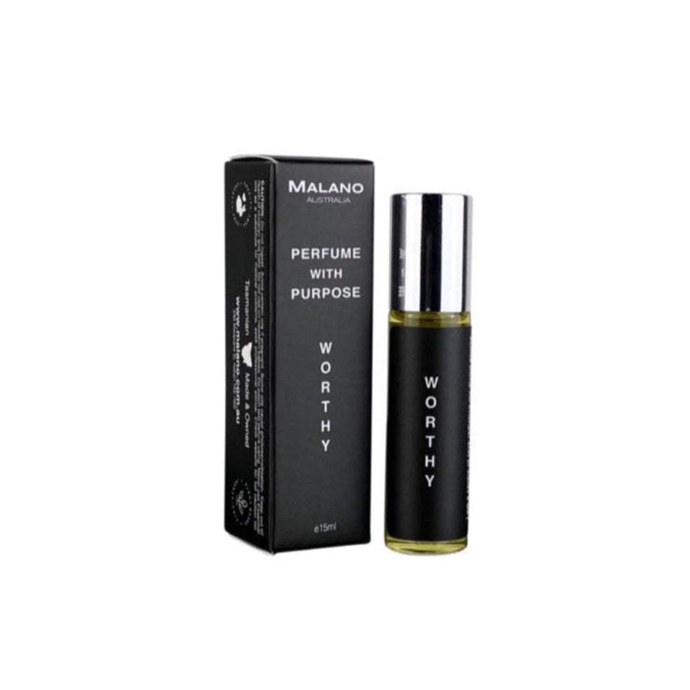 A clear, glass roll on perfume oil bottle with silver lid with a black and white label with Worthy, Perfume With Purpose and Malano written on it, and sitting next to its packaging box.