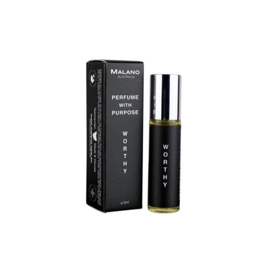 A clear, glass roll on perfume oil bottle with silver lid with a black and white label with Worthy, Perfume With Purpose and Malano written on it, and sitting next to its packaging box.